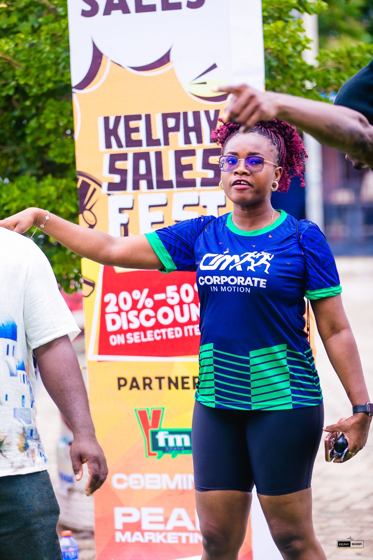 Festival guest beside a Kelphy Sales Fest banner