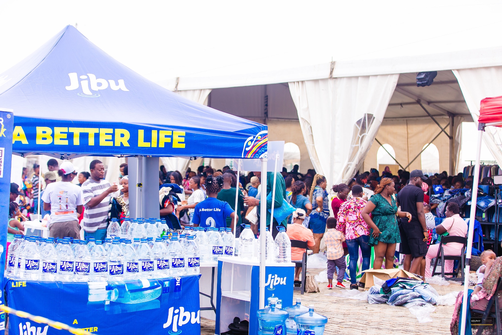 A busy Sales Fest tent with shoppers and the Jibu partner booth