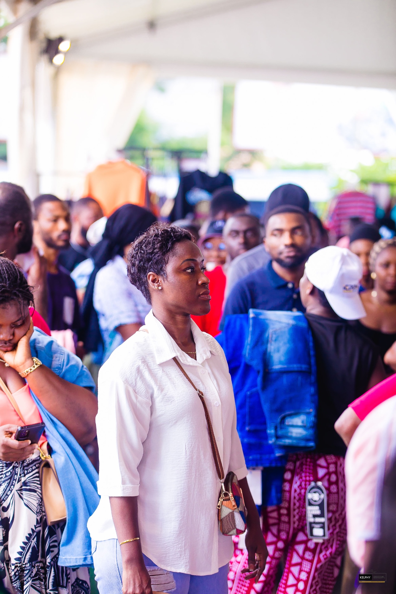 A guest smiling amid the Sales Fest shopping crowd